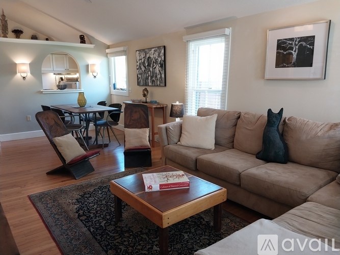 A living room with a couch, chairs, and a coffee table.