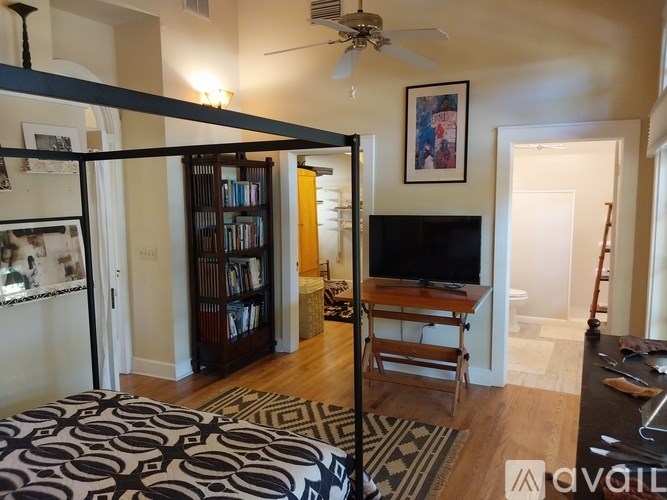 A living room with a television and a bookshelf.