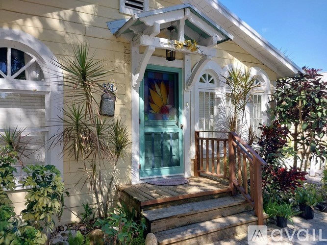 A house with a green door and a mailbox on the wall.