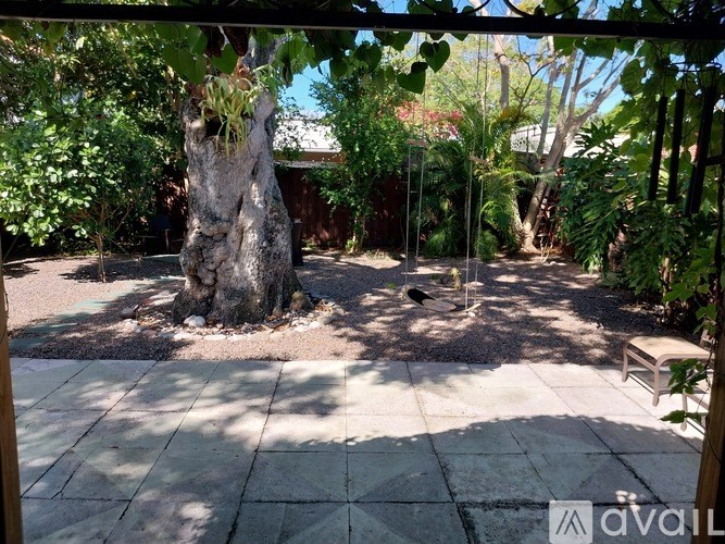 A tree stump sits in the middle of a patio.