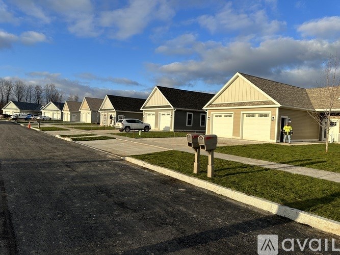 A row of houses with a mailbox in front.