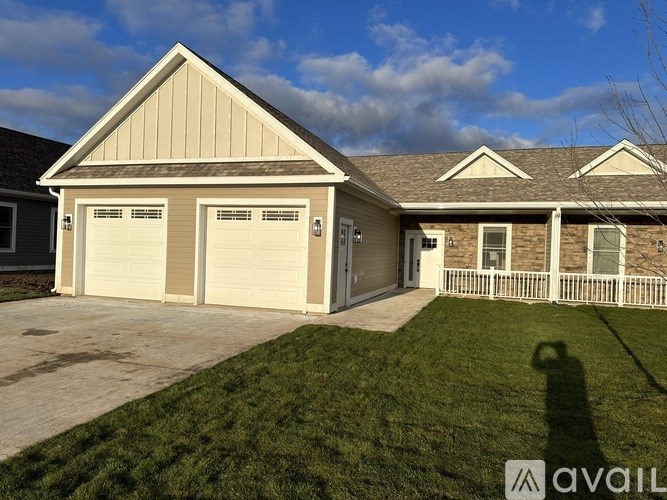 A two-car garage with a brown roof and tan siding is available for rent.