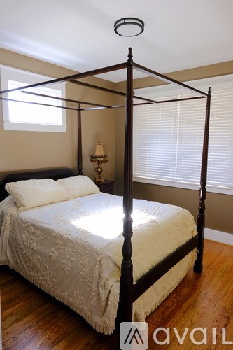 A bed with a white bedspread and a canopy.