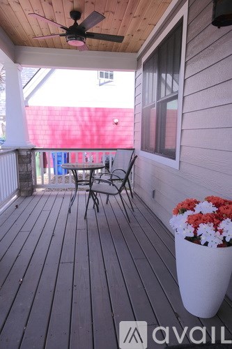 A wooden deck with a table and chairs.