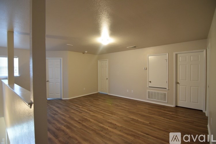 A room with wooden floors and white walls.