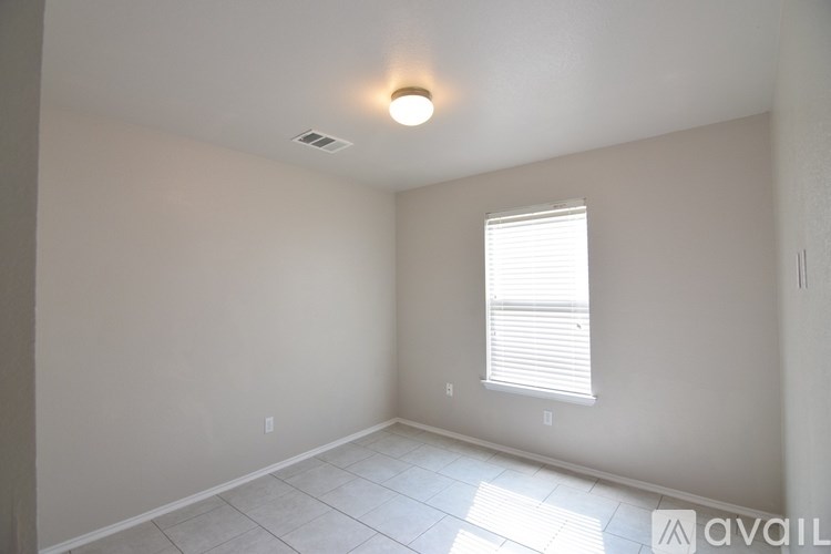 A room with a window and a light on the ceiling.