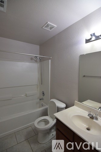 A bathroom with a toilet, sink, and bathtub.