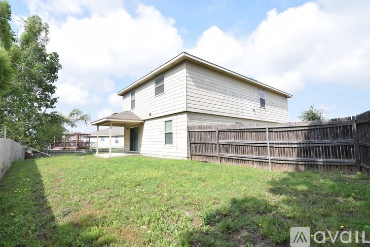 A house with a fence in front of it is for sale.