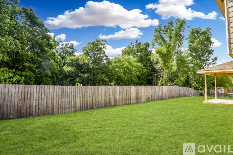 A spacious room with a ceiling fan and tile flooring.