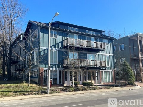 A modern two-story building with a balcony on the upper floor.