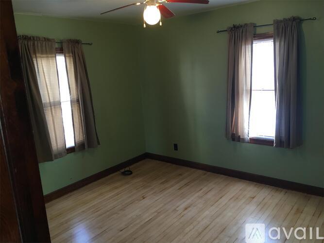 A room with a window and a ceiling fan.