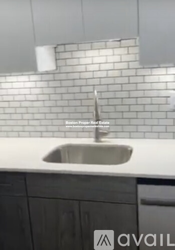 A kitchen with a sink and a countertop.
