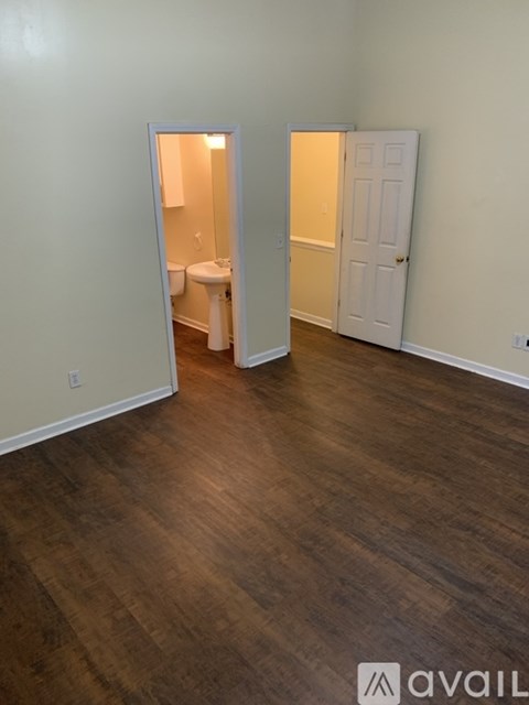 A room with a toilet and a door.