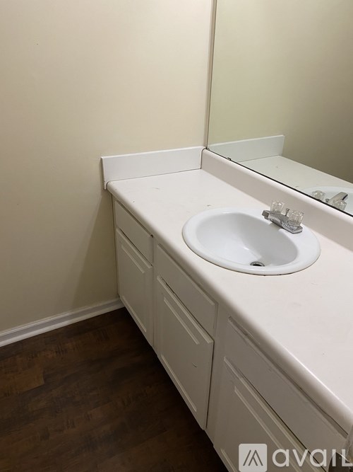 A white sink in a white cabinet in a bathroom.