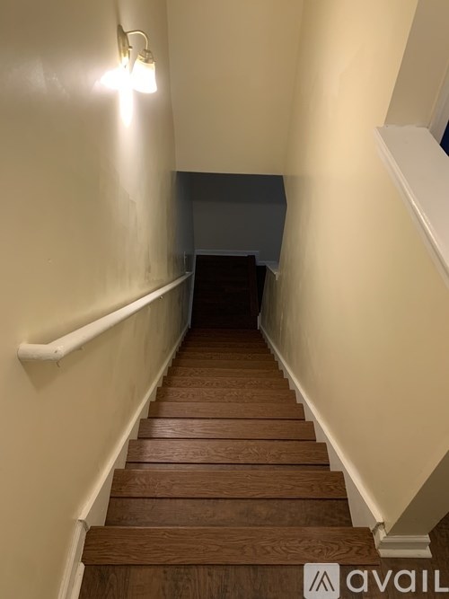 A staircase with wooden steps and white railings.