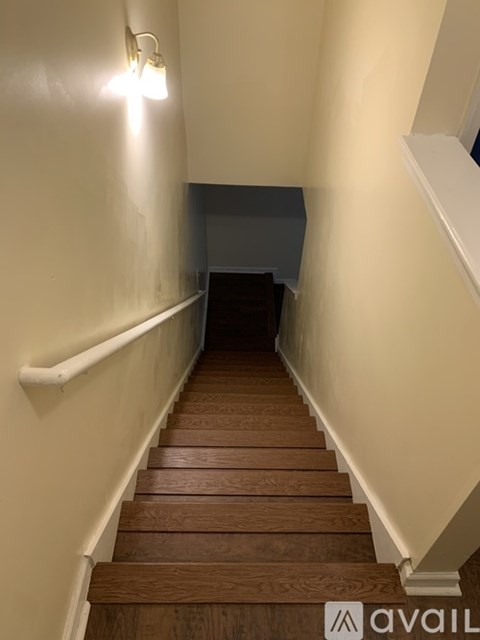 A staircase with wooden steps and white railings.