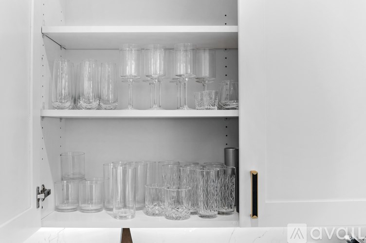 A shelf with glasses and cups on it.