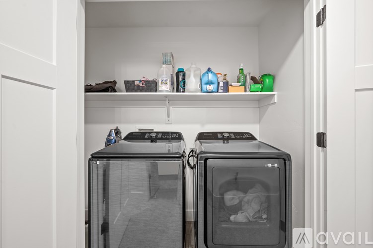 Two empty microwave ovens are placed in a kitchen.