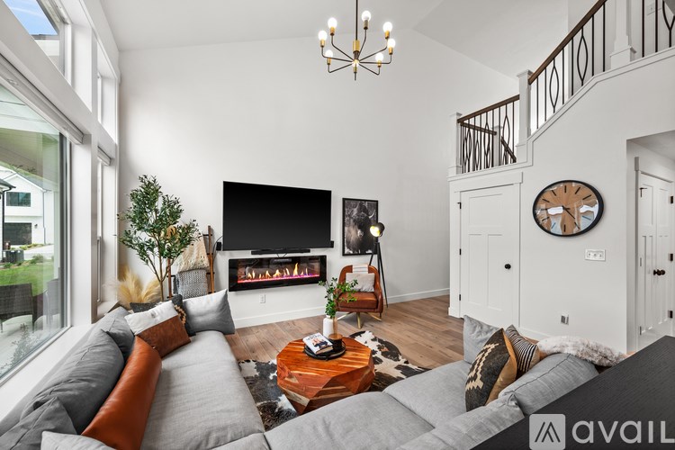 A living room with a grey couch and a wooden coffee table.