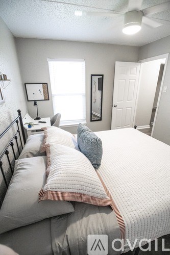 A bedroom with a large bed and a window.