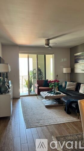 A modern living room with a sofa, a coffee table, and a rug.