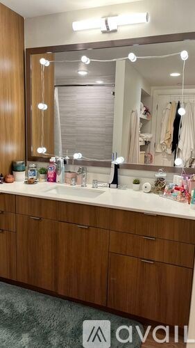 A bathroom vanity with a mirror and lights above it.