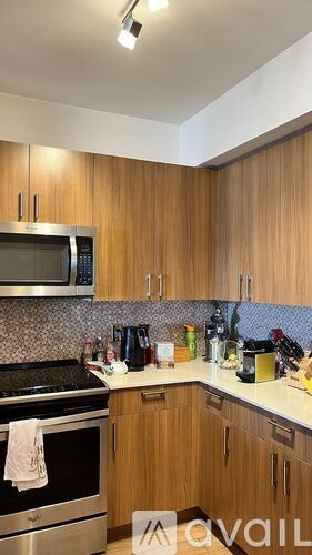 A kitchen with wooden cabinets and a stainless steel oven.