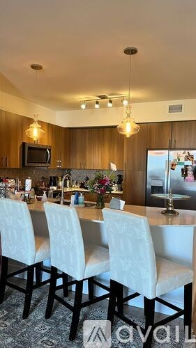 A kitchen with a dining table and chairs.