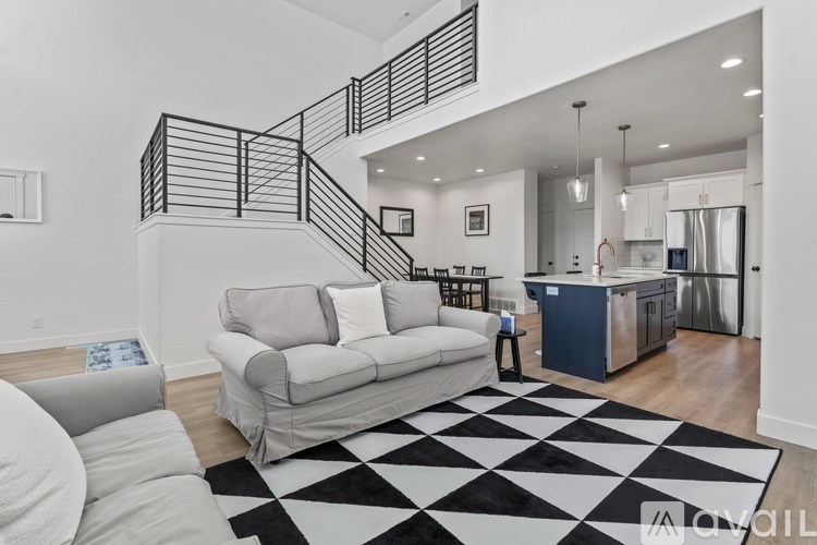 A black and white checkered rug is on the floor of a modern living room.