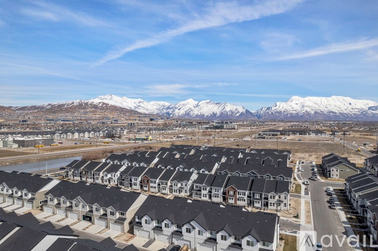A housing development with snow-capped mountains in the background.