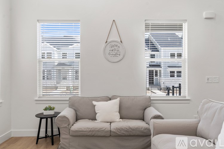 A living room with a grey couch and a small table.