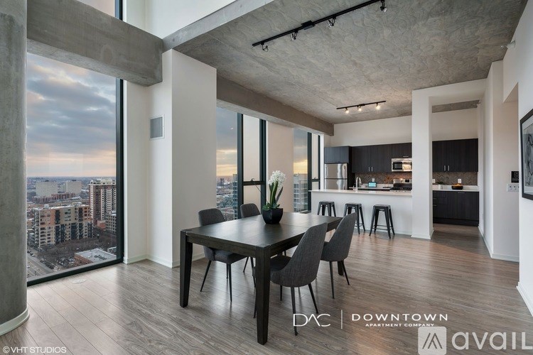 A modern dining room with a view of the cityscape outside the large window.