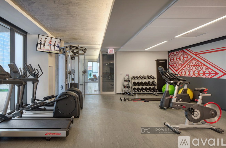 A gym with treadmills, weights, and exercise bikes.