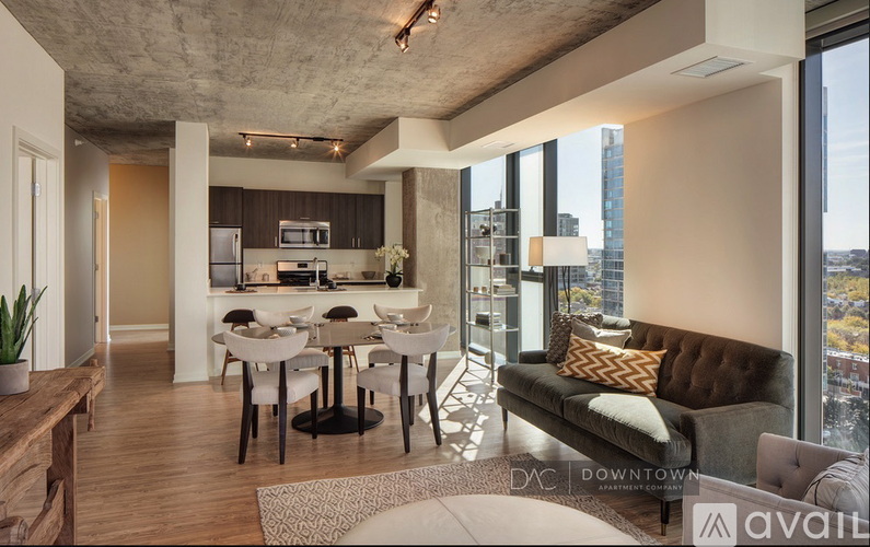 A modern kitchen with a dining table and chairs in the middle of the room.