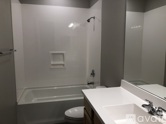 A bathroom with a white sink, toilet, and bathtub.