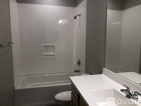 A bathroom with a white sink, toilet, and bathtub.