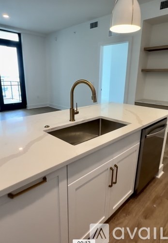 A kitchen with a sink and a window.