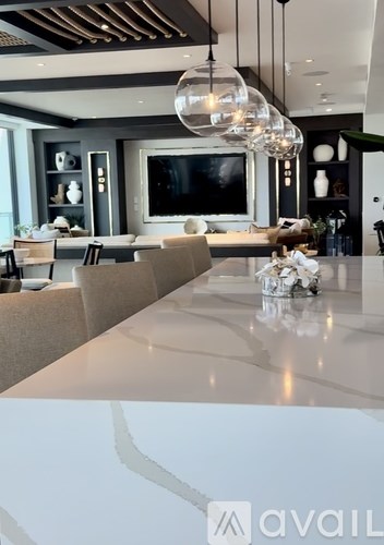 A modern dining room with a large table and chairs.