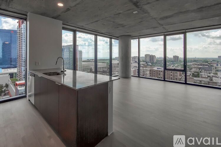 A modern kitchen with a stainless steel sink and wooden countertop.