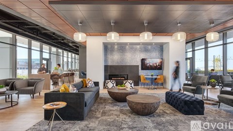 A modern living room with a fireplace and a large painting on the wall.