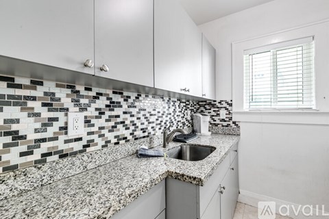 A kitchen with a sink and a window.