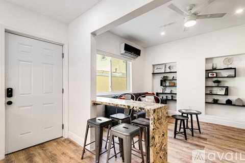 A room with a bar area and a door.