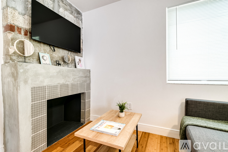 A living room with a fireplace and a flat screen TV mounted above it.