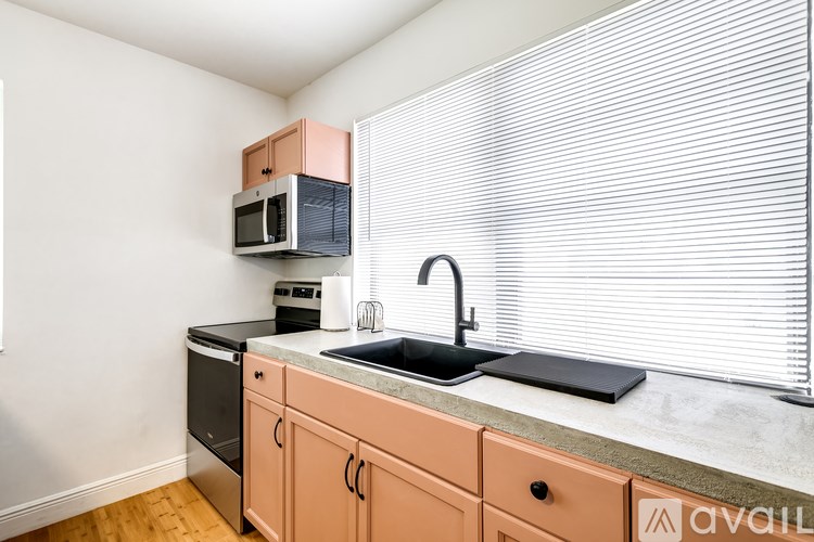 A kitchen with a sink, microwave, and dishwasher.