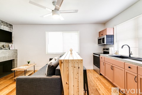 A living room with a grey couch and a wooden table.