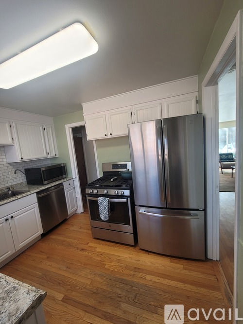 A kitchen with a stove top oven and a refrigerator.