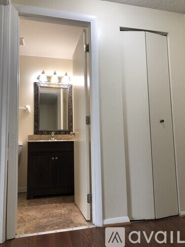 A bathroom with a mirror and a sink.