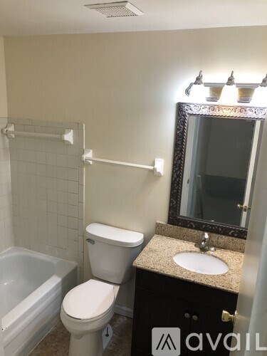 A bathroom with a toilet, sink, and bathtub.