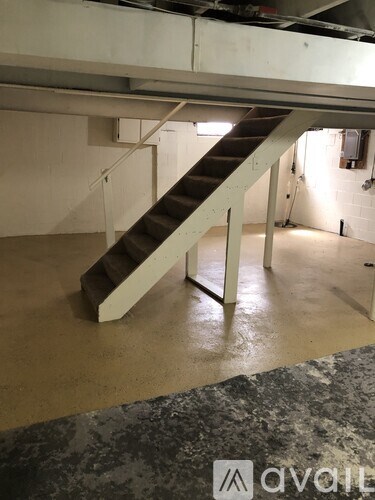 A staircase in a room with a concrete floor.