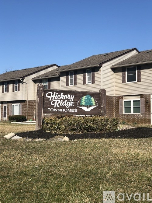 A sign for Hickory Ridge Townhomes stands in front of a building.